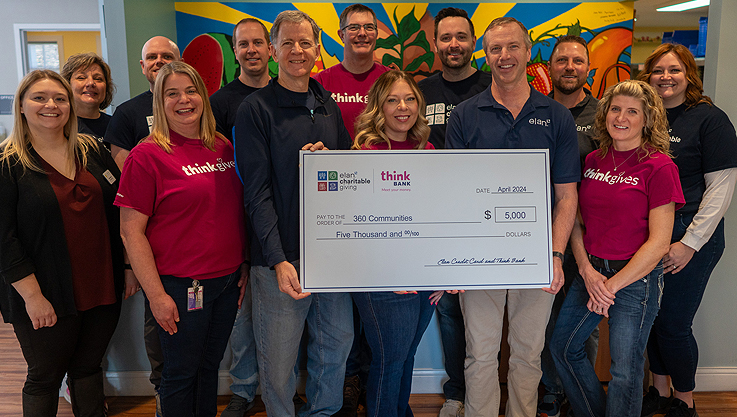 A group of individuals holding a large check